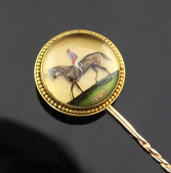 A Victorian unmarked gold and Essex crystal stock pin decorated with a horse and jockey, 3.5in.